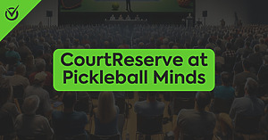 Conference hall filled with attendees, large screen displaying "CourtReserve at Pickleball Minds"