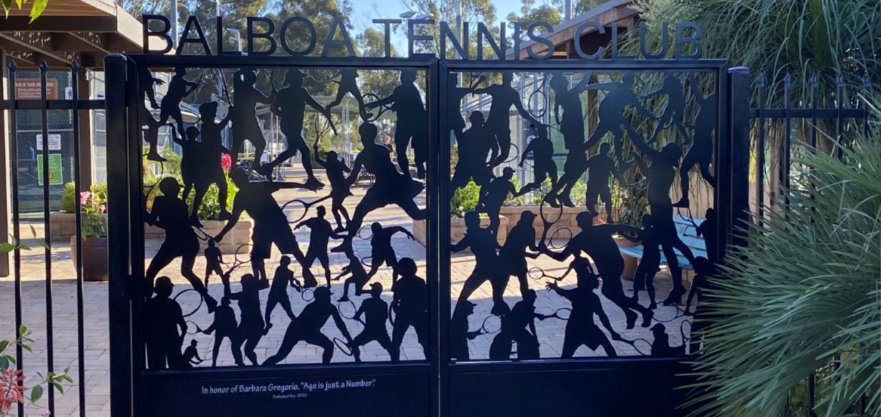 Silhouettes of people playing tennis at balboa tennis club with plants and buildings in background