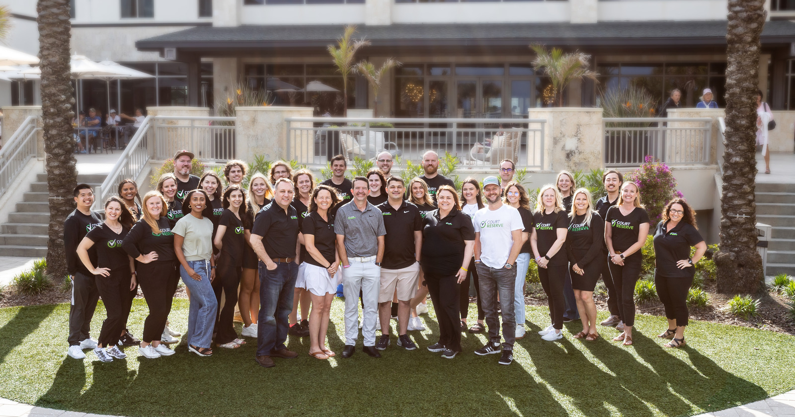 2025 Connect - Team Group of people posing outdoors in front of a building