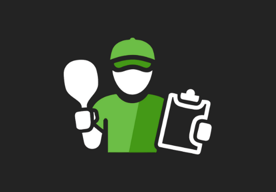 Person with a green cap holding a clipboard and a table tennis paddle